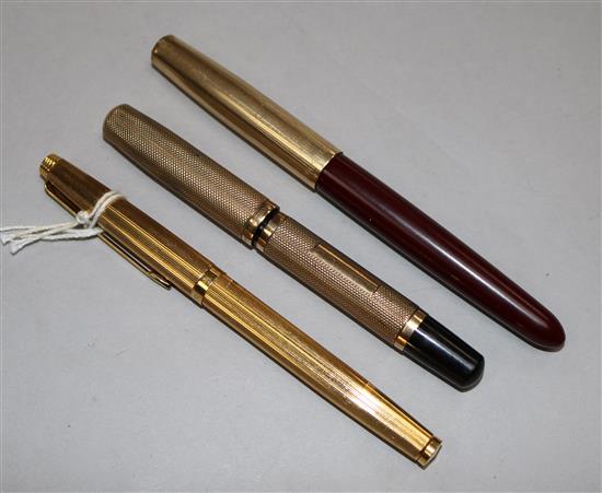 A 1930s 9ct gold Watermans Ideal Junior fountain pen and two gold plated Parker pens.